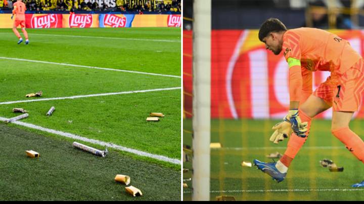 Borussia Dortmund fans throw gold bars on the pitch during Newcastle match as protest banner displayed