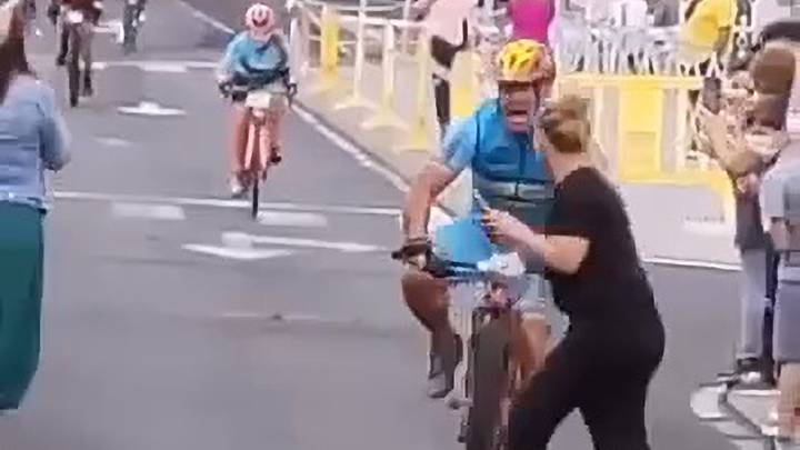 Spectator Taken Out By Cyclist While Sprinting To Finish Line During Race 