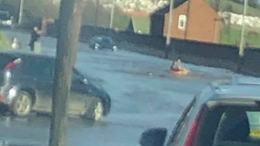 People Are 'Surfing' And 'Canoeing' On A Flooded Road In Leeds 