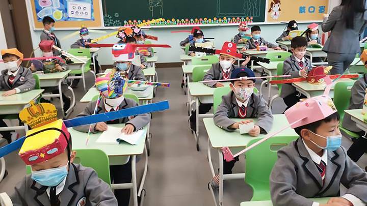 Students In China Wear Homemade Social Distancing Hats As They Return To School