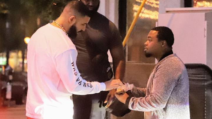 Drake Hands Hundred-Dollar Bills To Man In Street