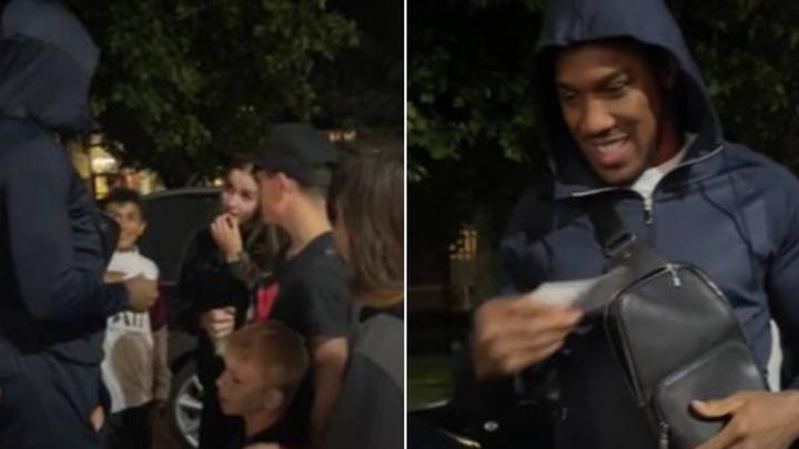 Anthony Joshua hands out wads of cash to children at his local estate