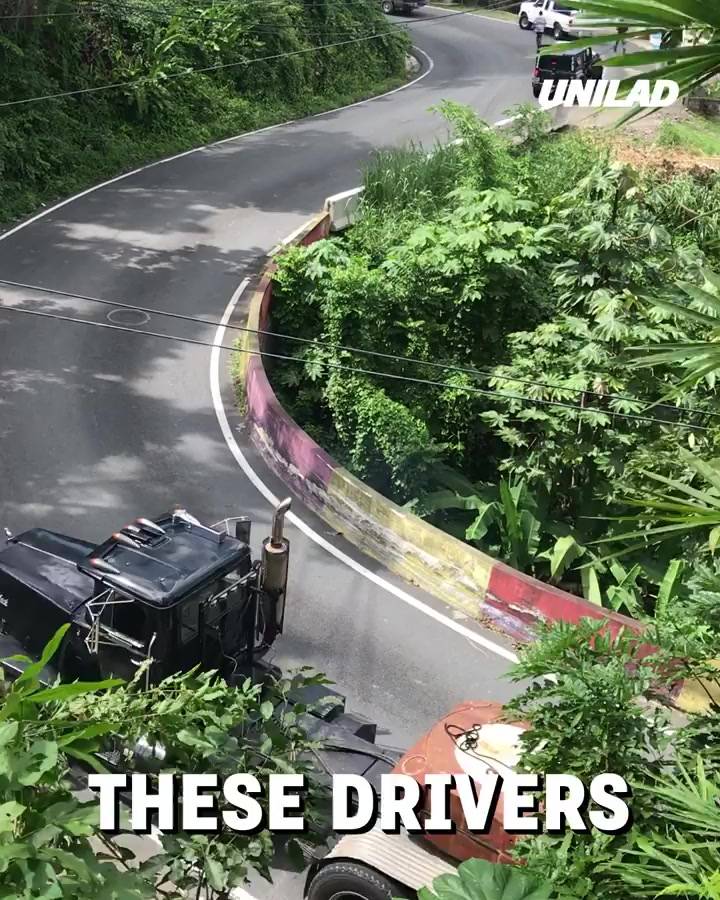 Skilled drivers navigate winding road with bridge beam