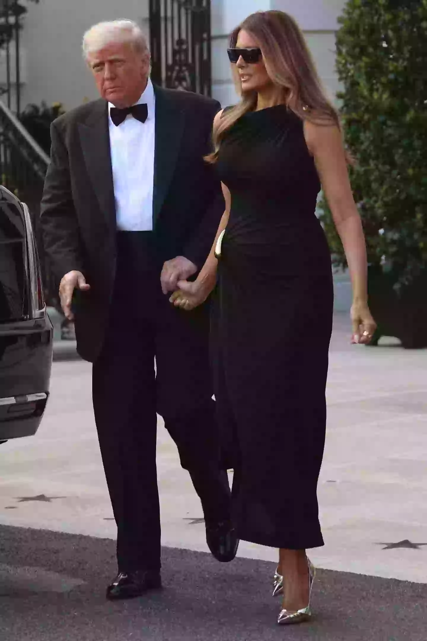 Trump can be seen holding his wife's thumb (ALEX WROBLEWSKI/AFP via Getty Images)