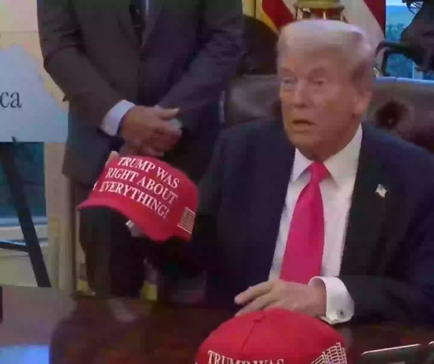 Donald Trump showed off his new 'TRUMP WAS RIGHT ABOUT EVERYTHING' caps at the Oval Office on Tuesday (Instagram/@whitehouse)