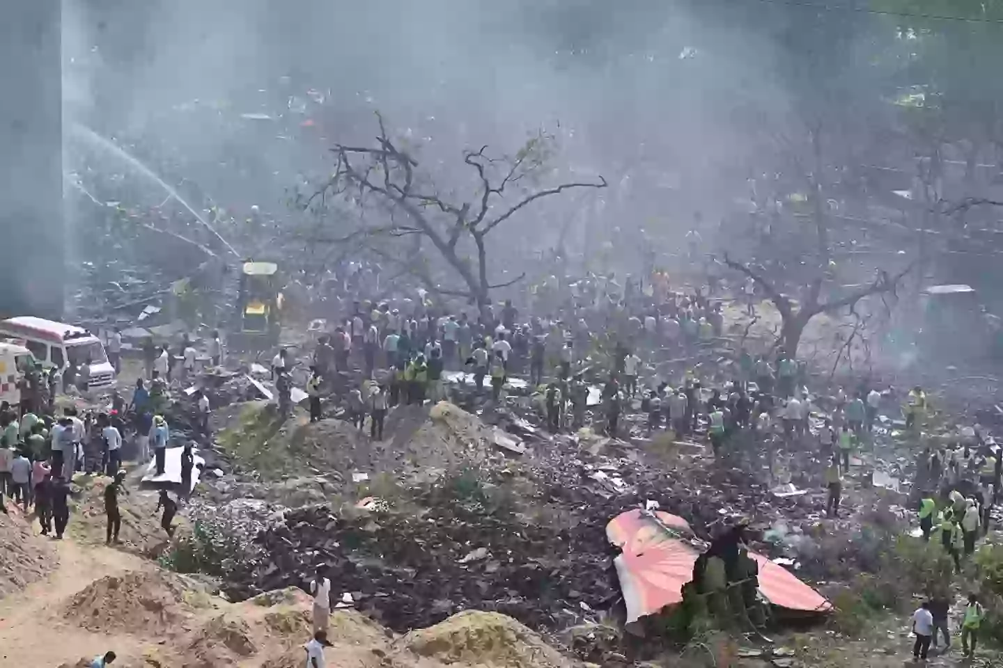 A view of the site where a plane crashed shortly after takeoff from Sardar Vallabhbhai Patel International Airport in India's western state of Gujarat today (Stringer/Anadolu via Getty Images)