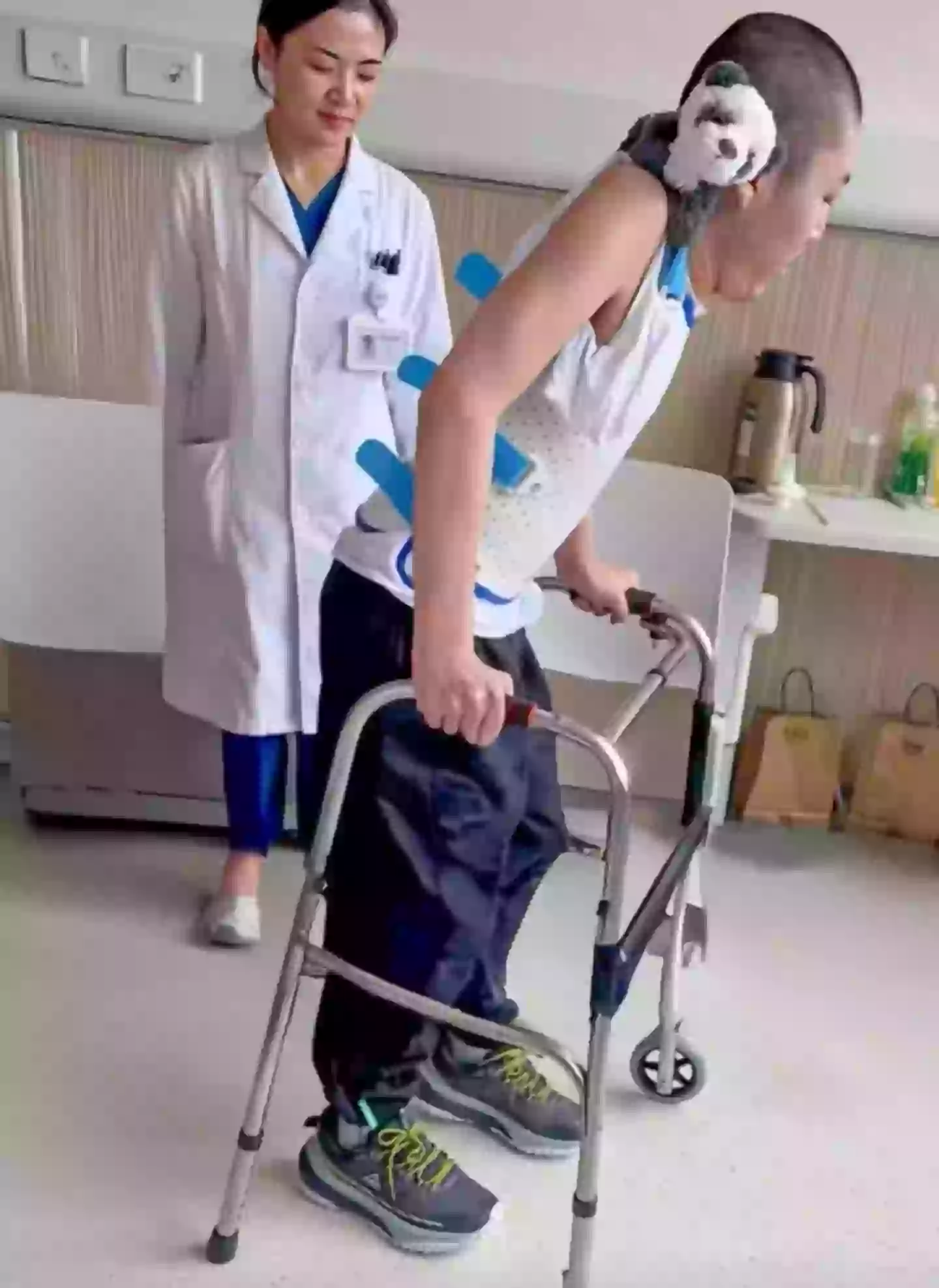 Two months after his final surgery, Jiang took his first upright steps (YouTube/South China Morning Post)