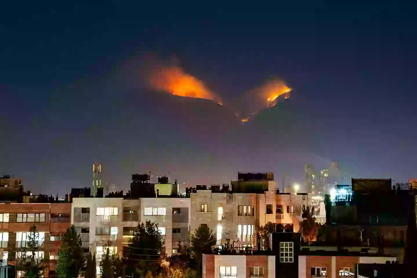 Smoke and flames can be seen at an alleged nuclear site in the mountains of Shiraz, Iran (HIROON/Middle East Images/AFP via Getty Images)