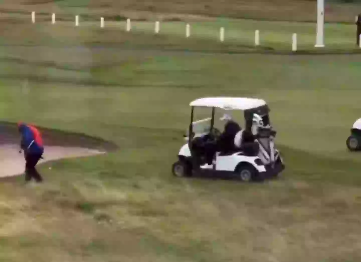 The caddy can be seen 'dropping' the ball ahead of Trump (Twitter)