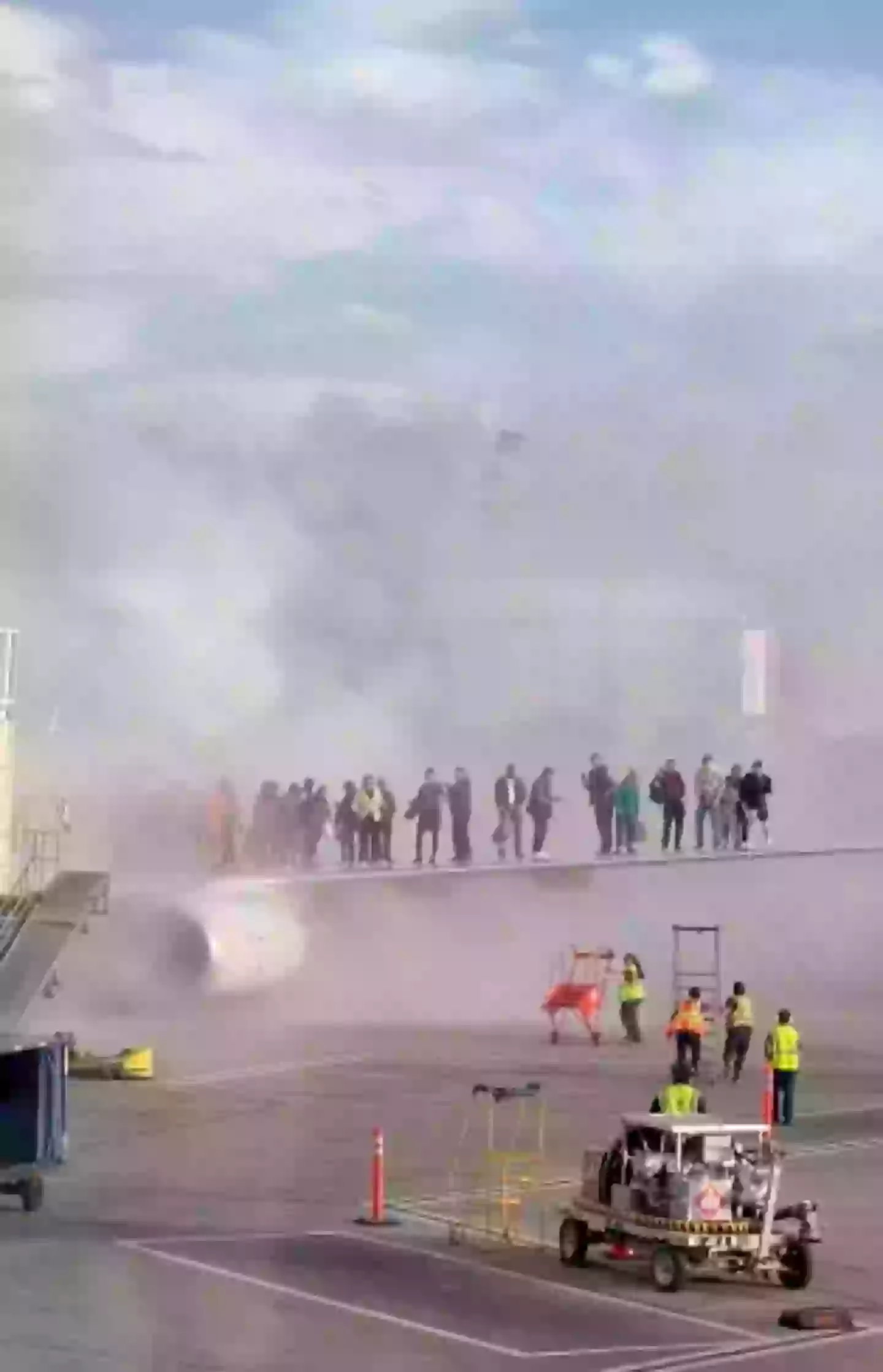 Dozens of passengers could be seen cramming on the wings of the jet as it caught fire (Twitter/@flynnstone)