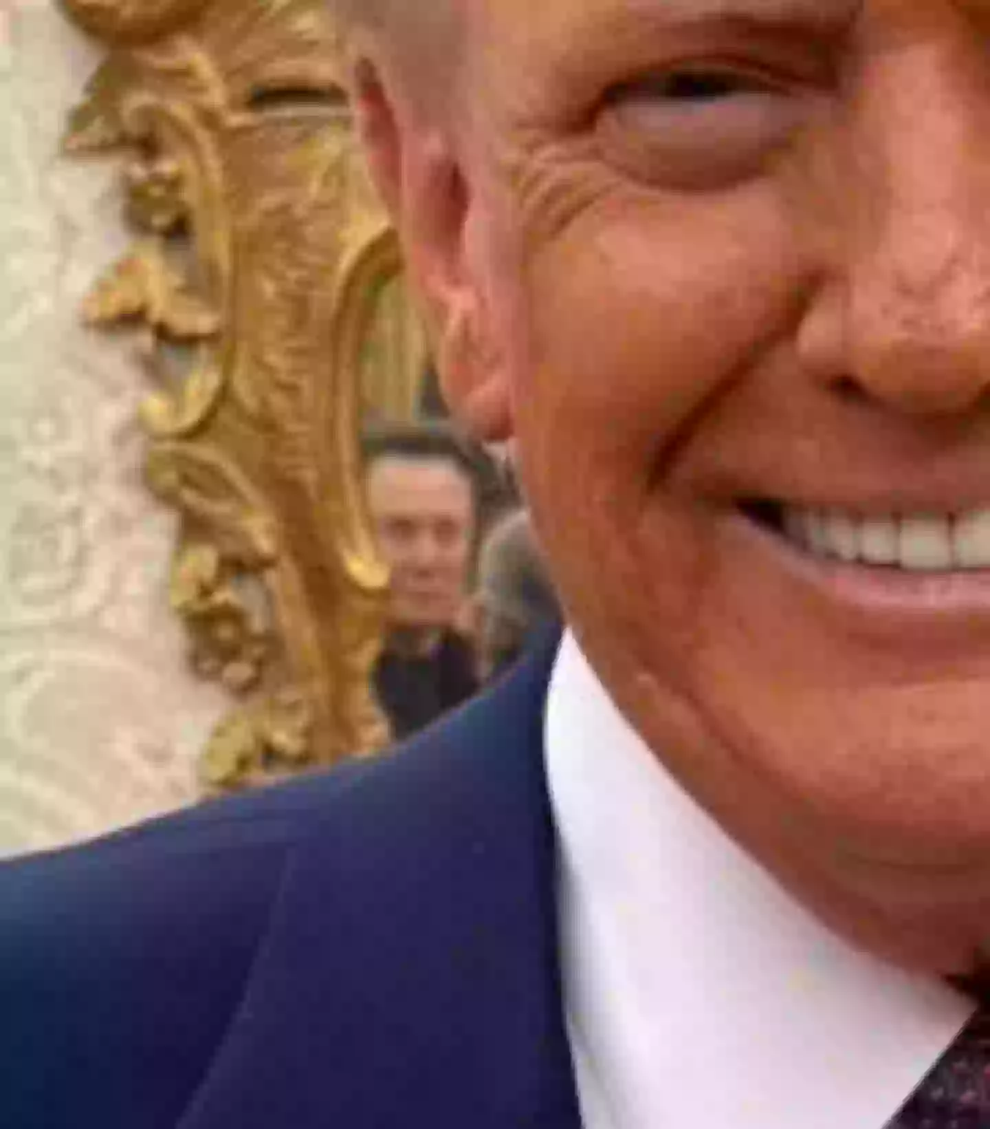 Elon Musk can be seen lurking in the mirror behind Trump's ear (X/@bscholl)
