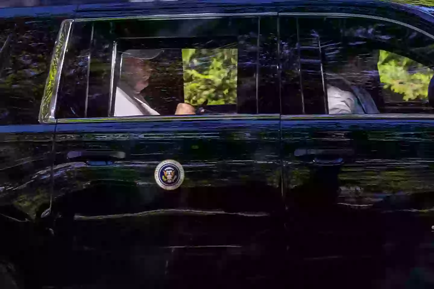 President Donald Trump checks his phone on Sunday, having spent the day at Trump National Golf Club (Tasos Katopodis/Getty Images)