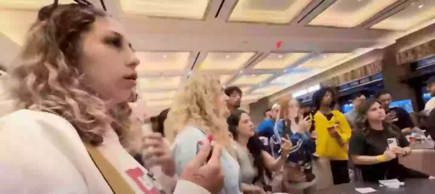 Dozens gathered in the hotel lobby in protest (8 News Now/YouTube)