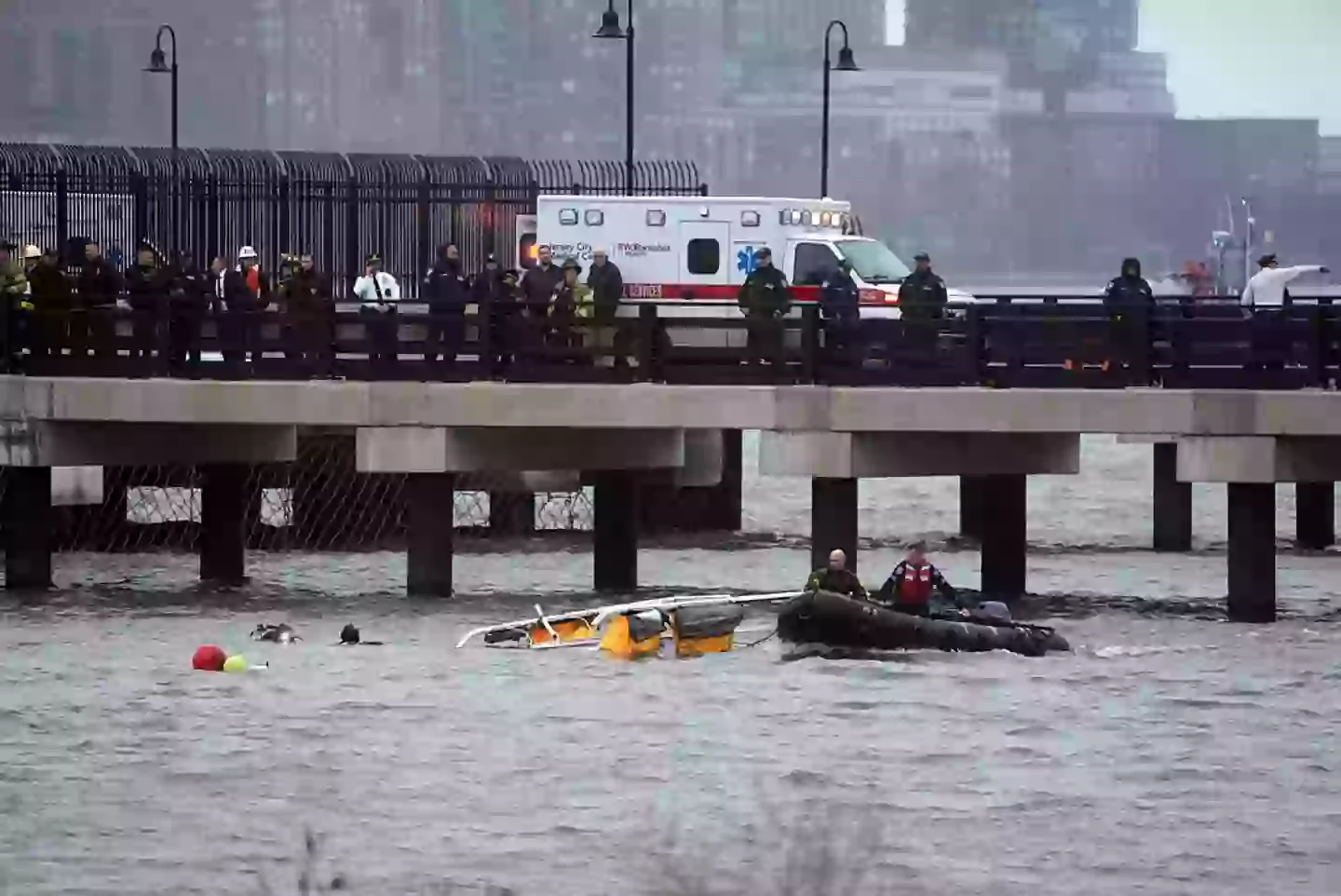 Police and firefighters work on the site after a helicopter crashed into the Hudson River near lower Manhattan, on April 10 (Lokman Vural Elibol/Anadolu via Getty Images)