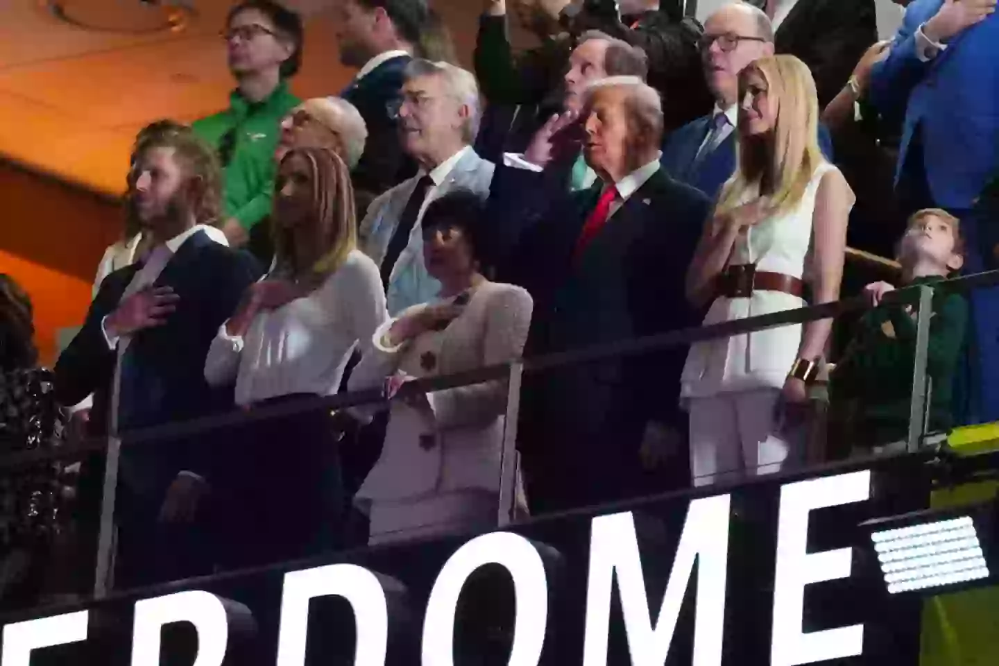 President Donald Trump salutes during the national anthem (Cooper Neill/Getty Images)