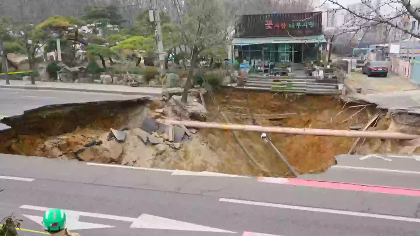 Motorcyclist dies after massive sink hole opens up in middle of the road prompting 18 hour search
