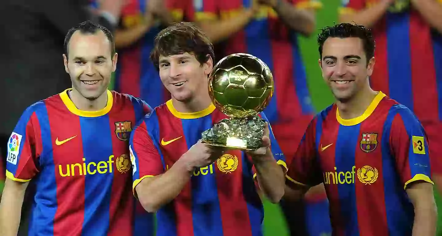 Lionel Messi pictured with the Ballon d'Or award, flanked by Andres Iniesta and Xavi (Image: Getty)