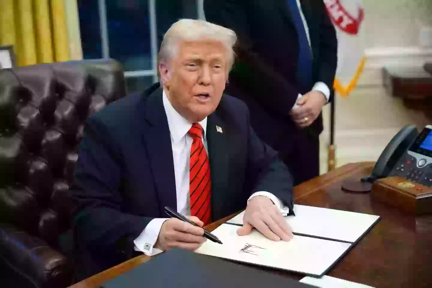 Trump signs a series of executive orders in the Oval Office at the White House on February 10, 2025. Image credit: Getty