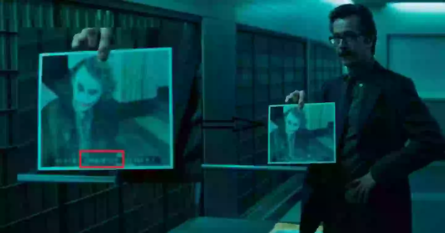 Gordan holding photo of Joker