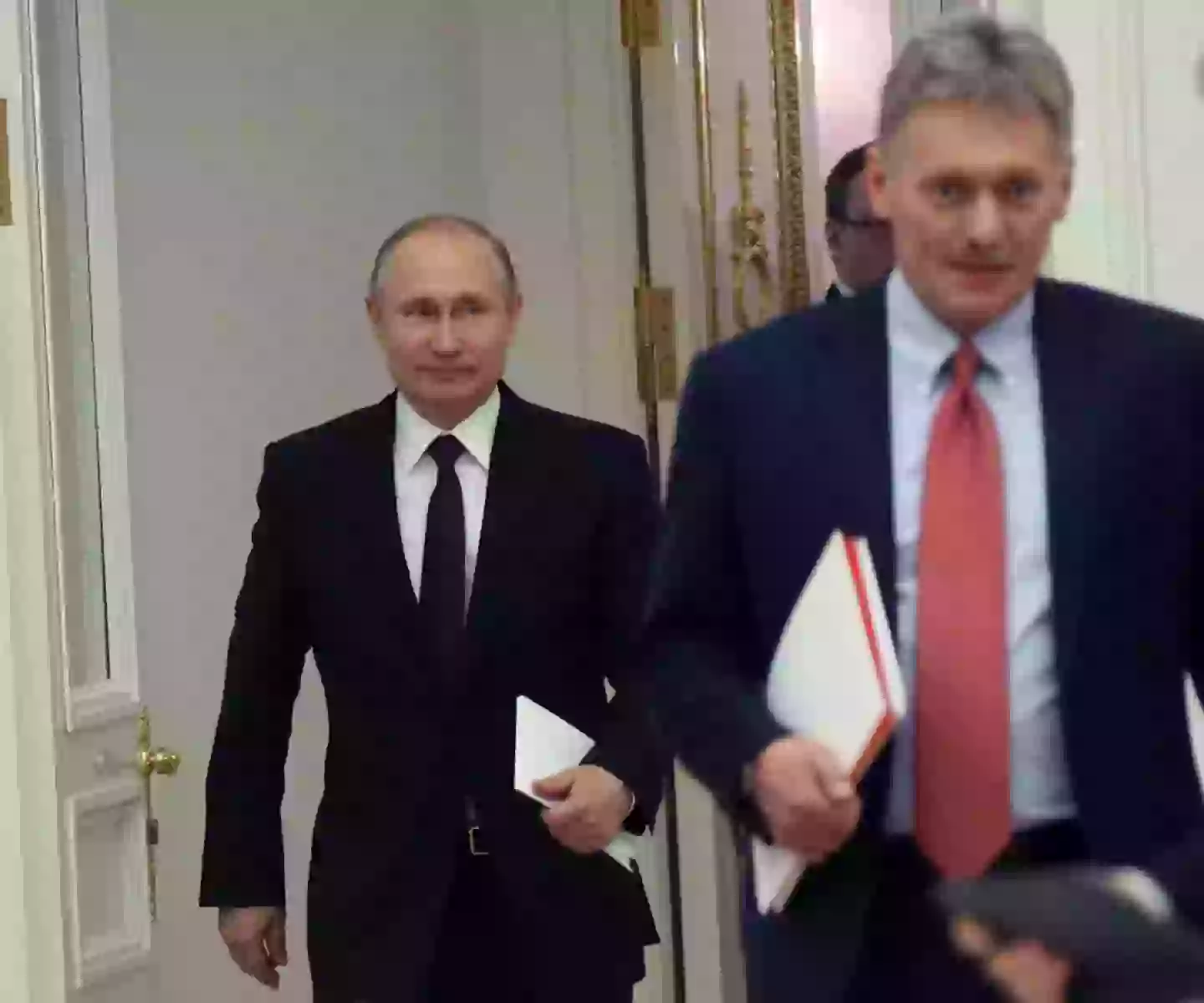 Russian President Vladimir Putin and Kremlin spokesman Dmitry Peskov (Mikhail Svetlov/Getty Images)