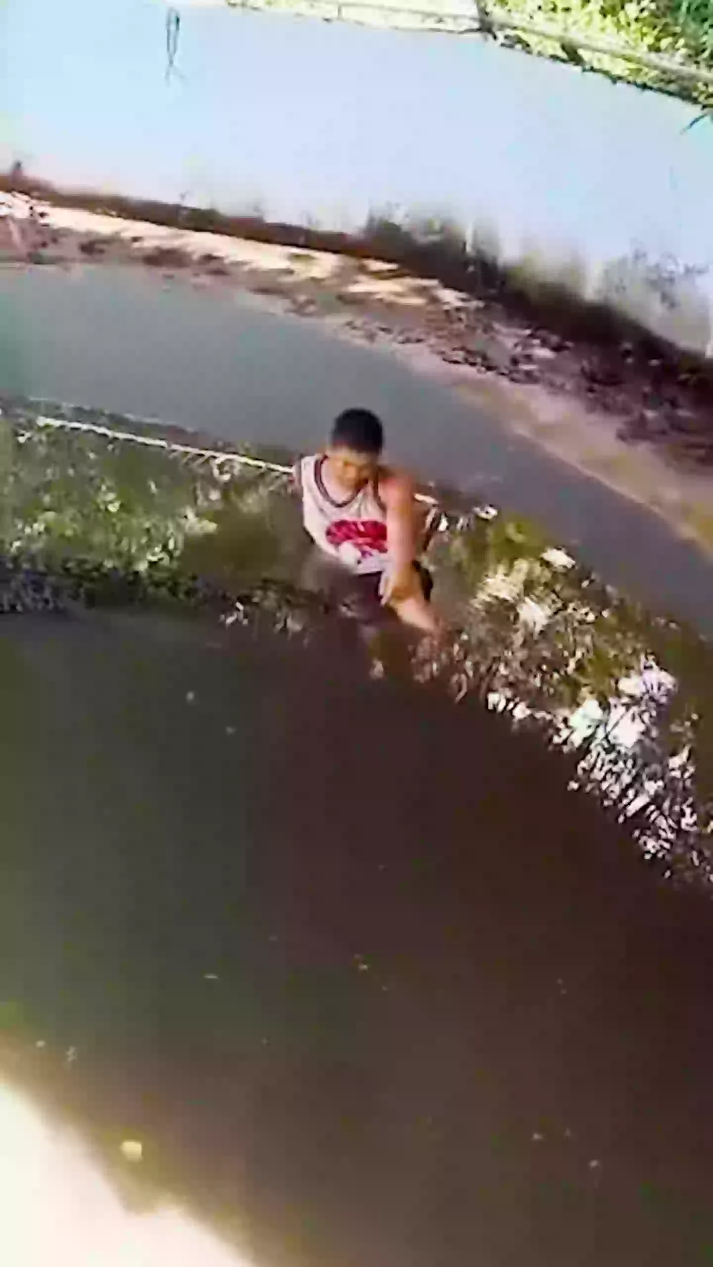The tourist claimed he thought the crocodile was a statue because it wasn't moving, so climbed in for a selfie (ViralPress)