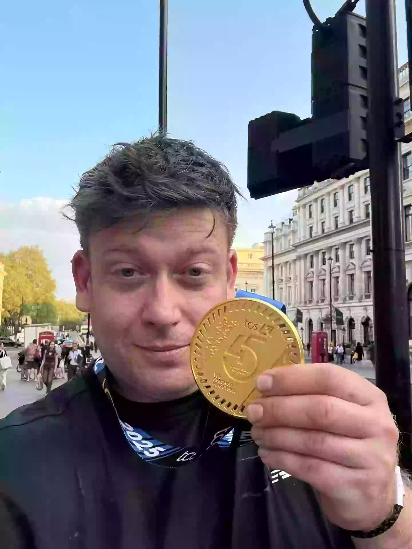 Ceri, pictured with this year's London Marathon medal, his first marathon medal from 2021 was buried with his son (X/@ItsNeverYou22)