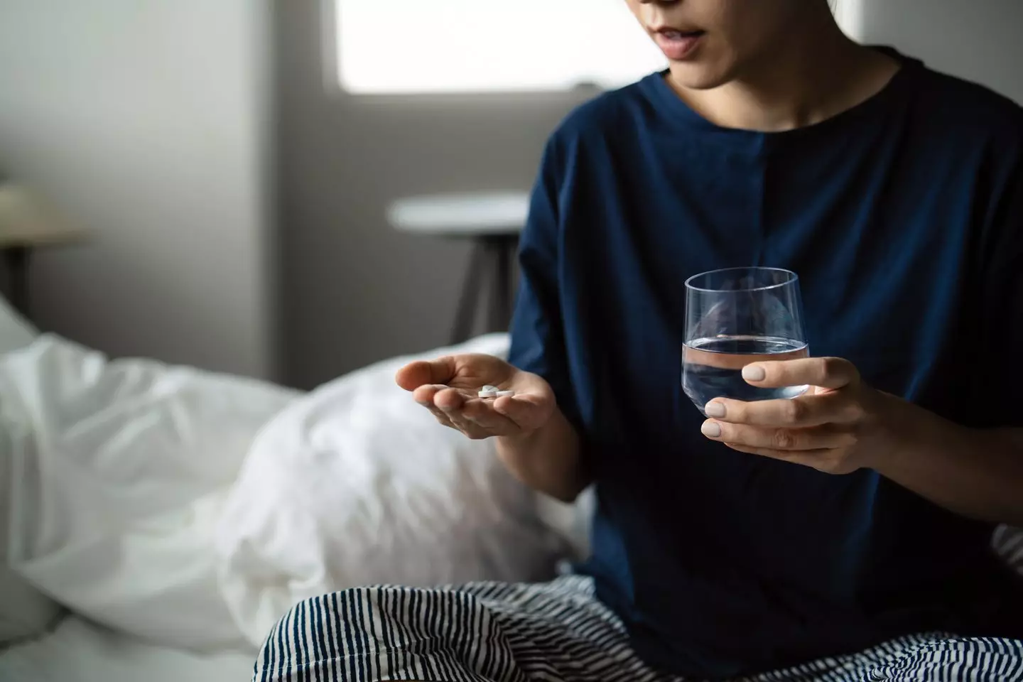 Taking your pills with cold water may not be as effective as using them alongside a wam liquid, like coffee (Getty Stock Image)