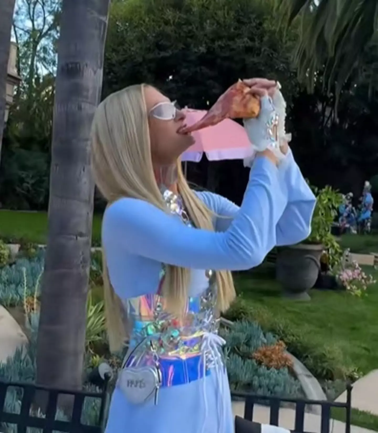 Paris tucking into her slice (parishilton/TikTok)