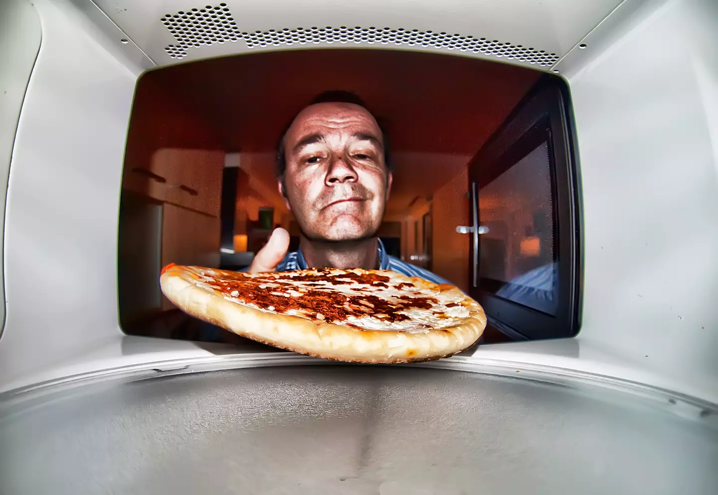 The hack advises to put your leftover slices in the microwave along with a microwave-safe mug that’s half-full of water (Santiago Bañón/Getty Images)