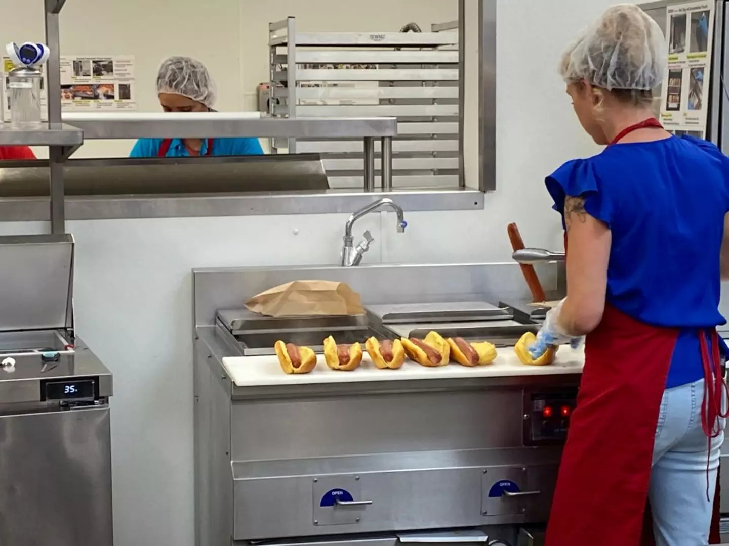 Costco's hot dogs being prepared (UCG / Contributor/Getty Images)