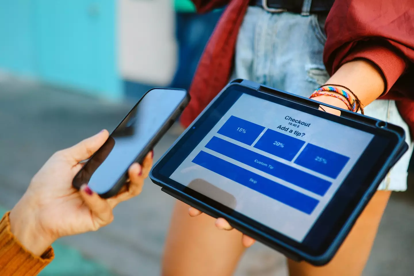 Credit card companies often charge businesses for processing each transaction (lechatnoir/Getty)
