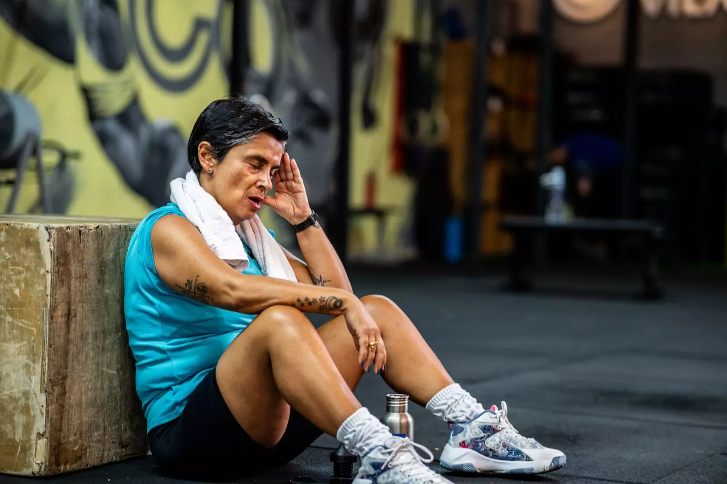 A woman getting a headache in the gym, a common occurrence for many (FG Trade/Getty Images))