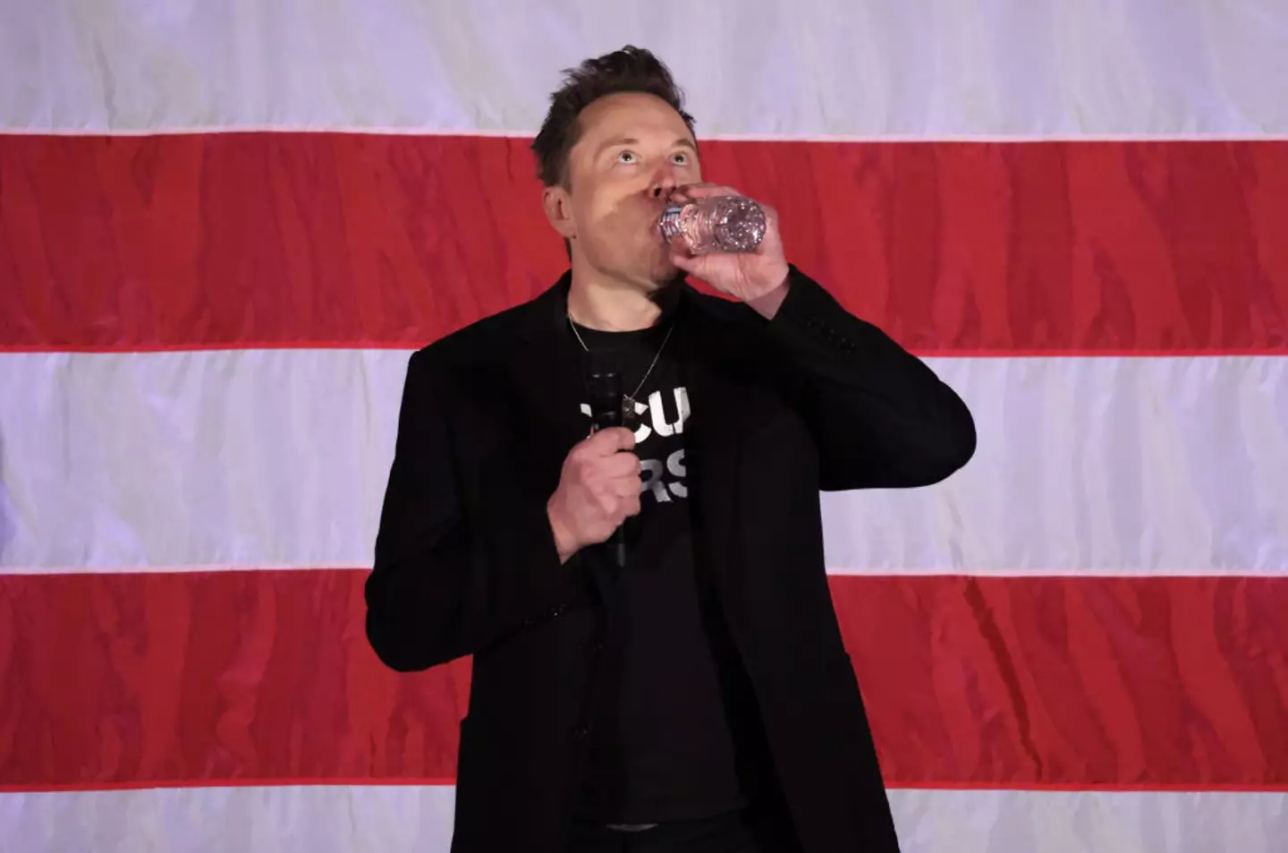 He might be sipping a glass of water here, but Musk has said he loves to drink Diet Coke (Alex Wong/Getty Images)