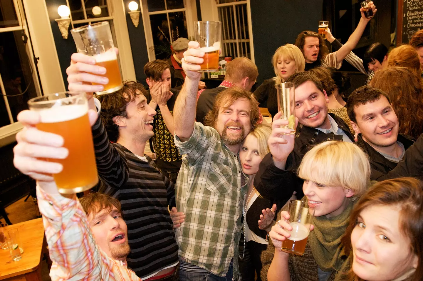 Partygoers enjoying a drink - John Rensten via Getty Images