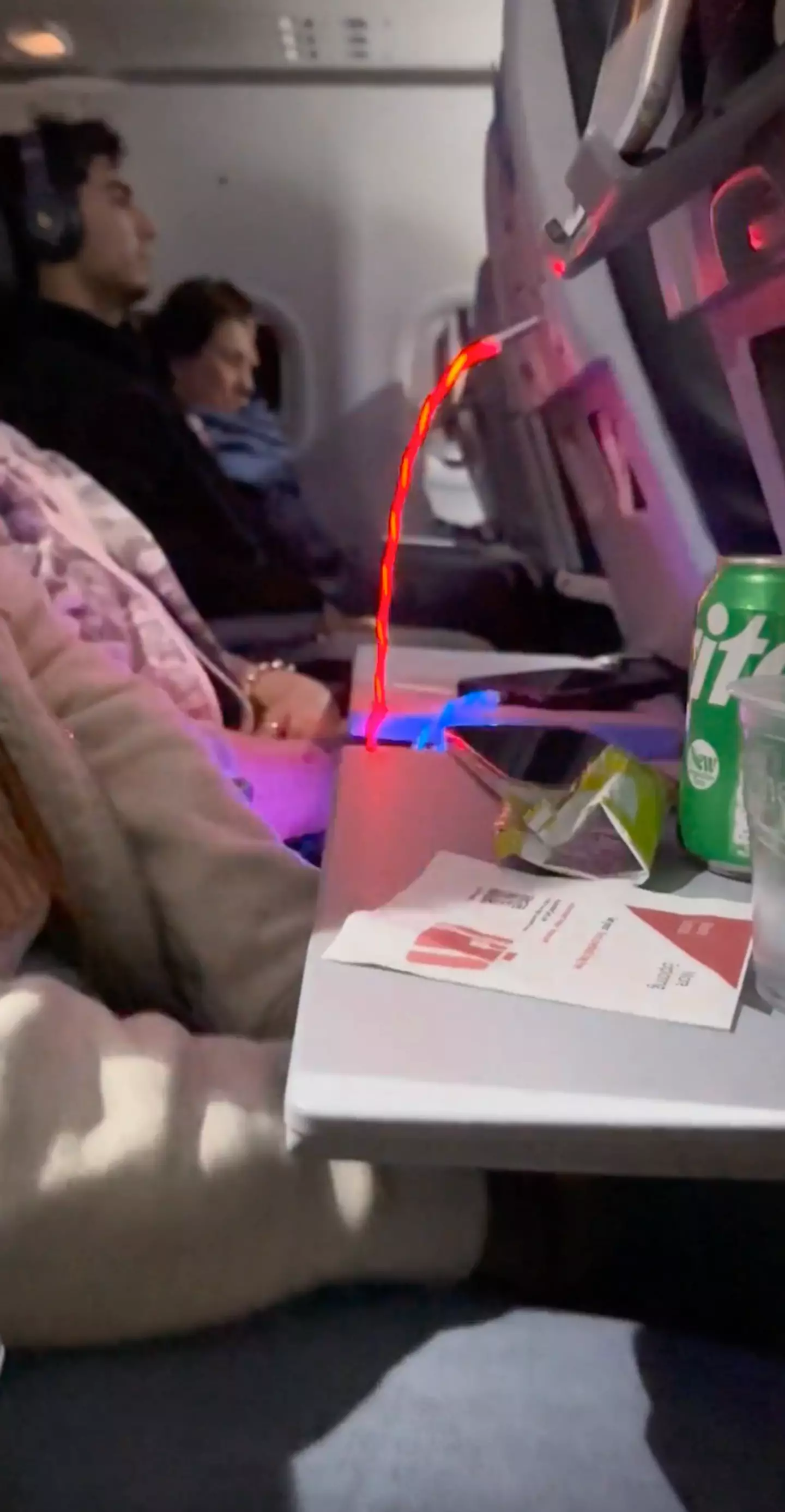 People called out the passenger for the 'horrendous' flashing cable.