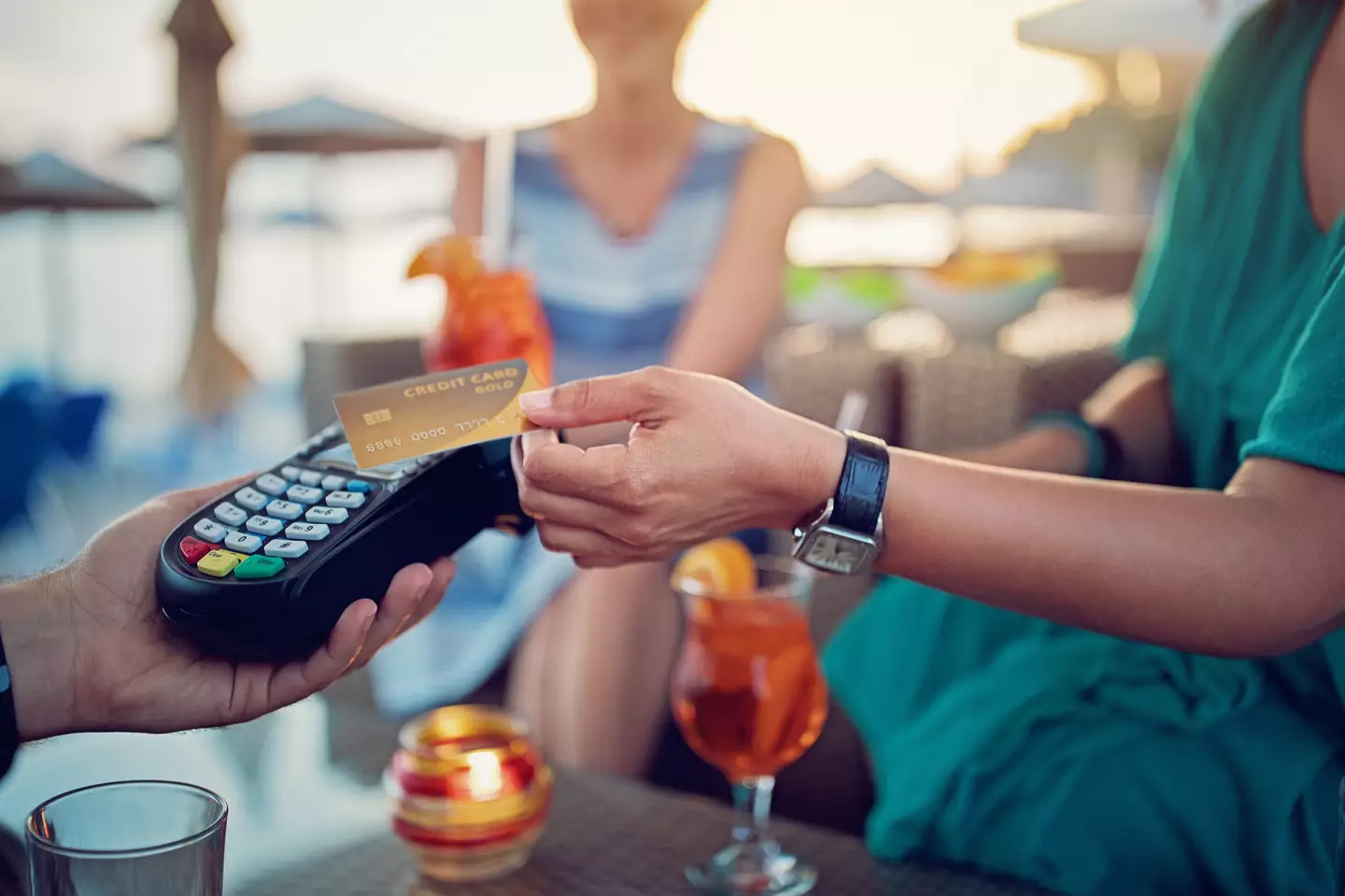 You could be hit with fees of around three per cent from your card provider if you don't pay in local currency. (praetorianphoto/Getty Images)