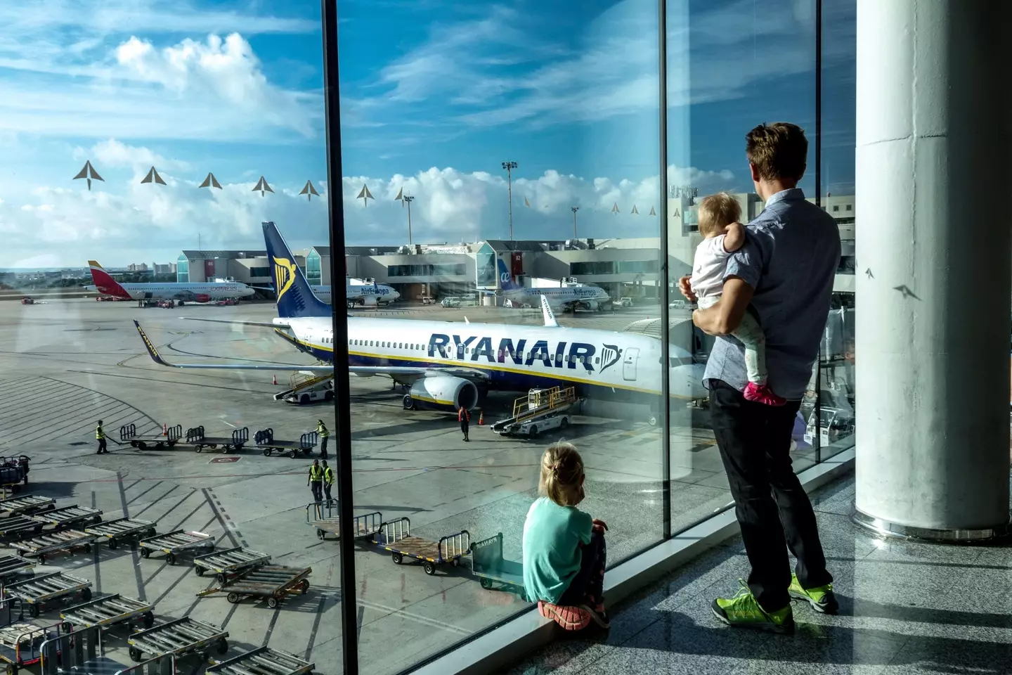 A family waiting to board a plane.