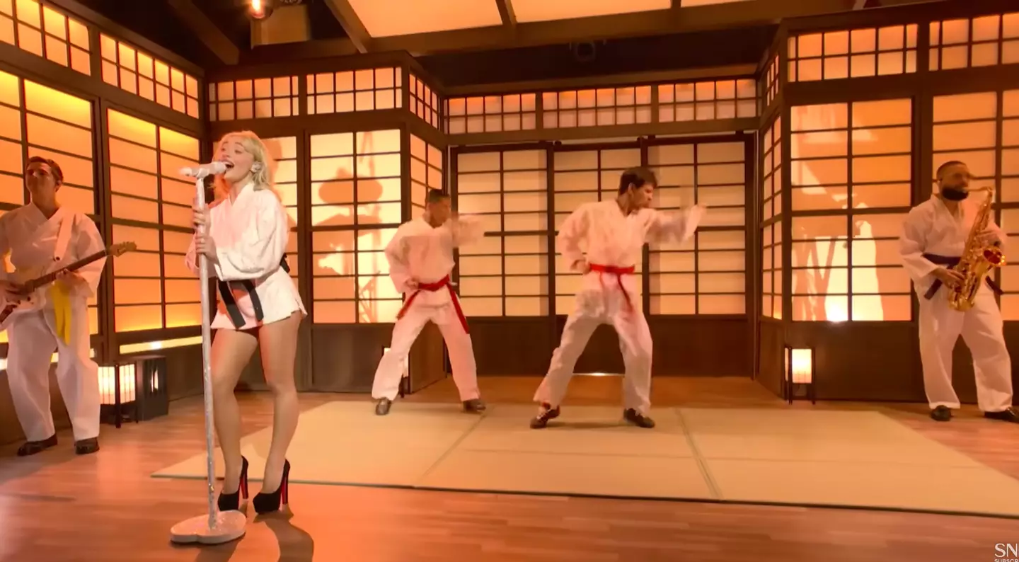 The backlash comes from her backing performers wearing shoes while on the tatami mats (SNL)