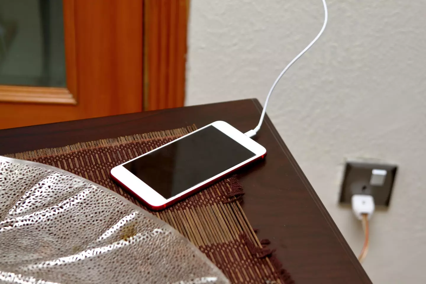 Pop your phone on your bedside table to charge rather than in your bed to avoid overheating. (Amir Mukhtar / Getty Images)