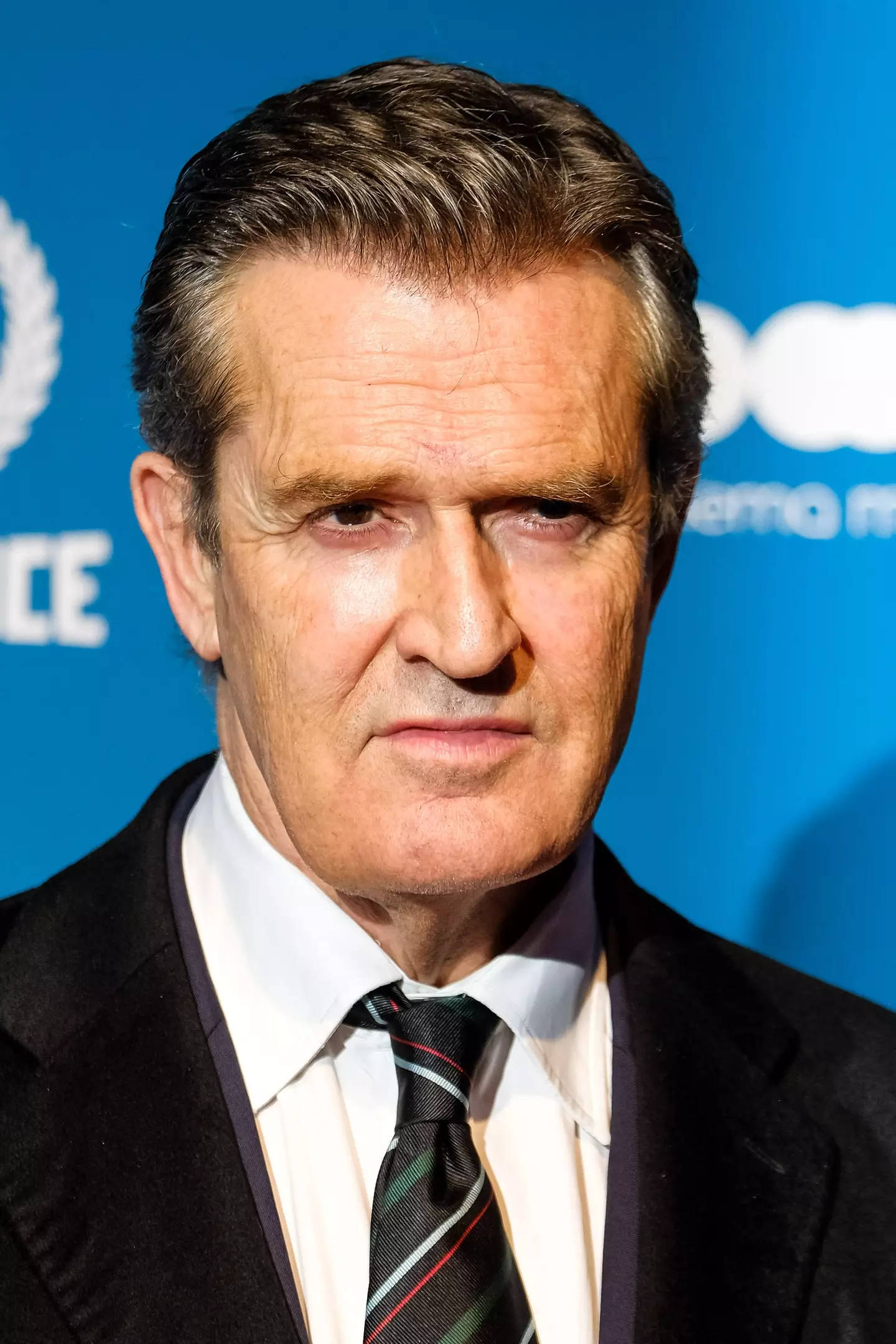 Rupert Everett says he knows who the mystery woman is.