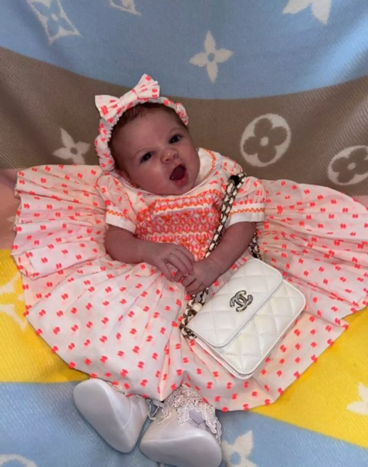 Six-week old Queeniana already has an impressive designer wardrobe.