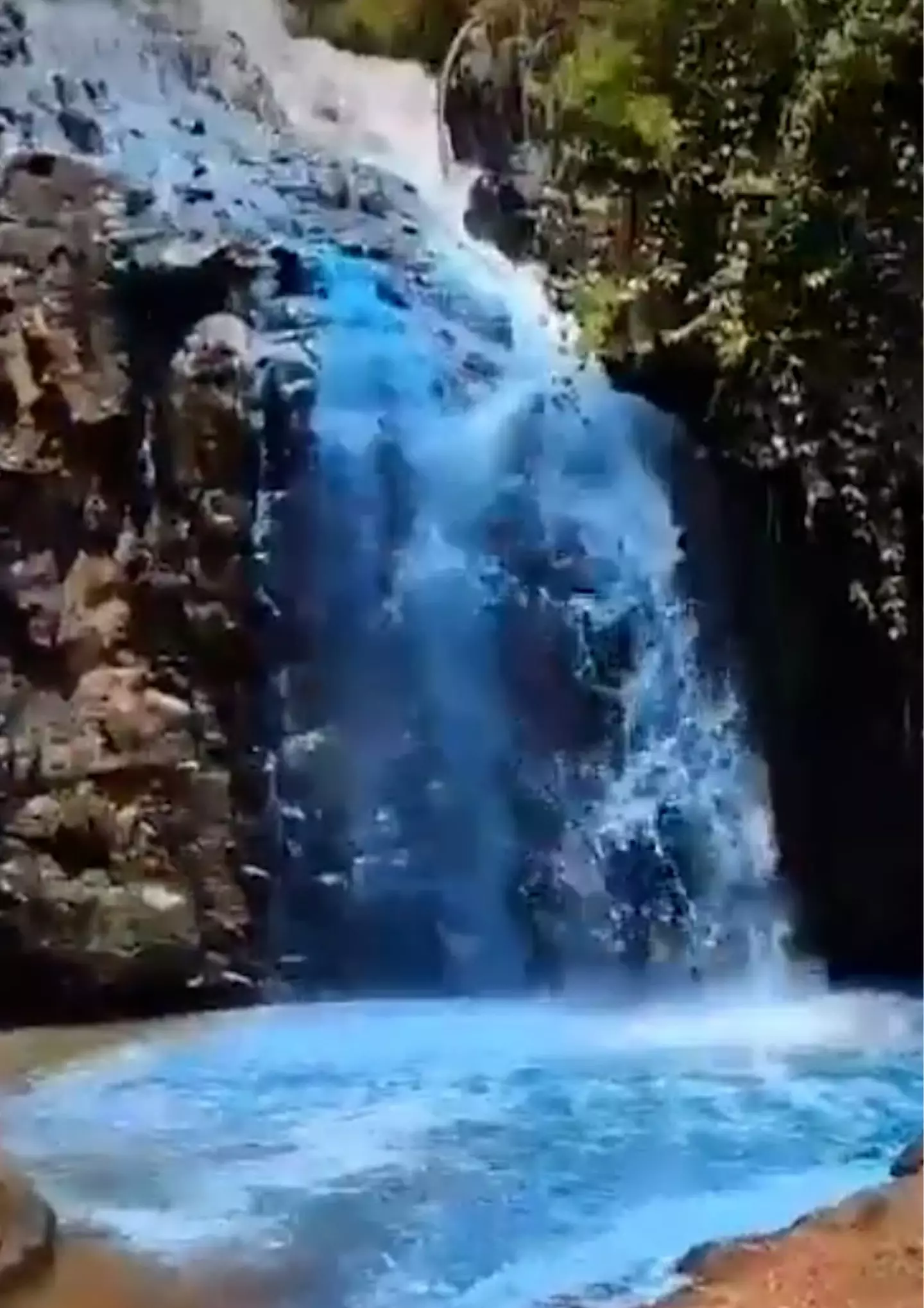 The natural waterfall was dyed blue for the occasion.