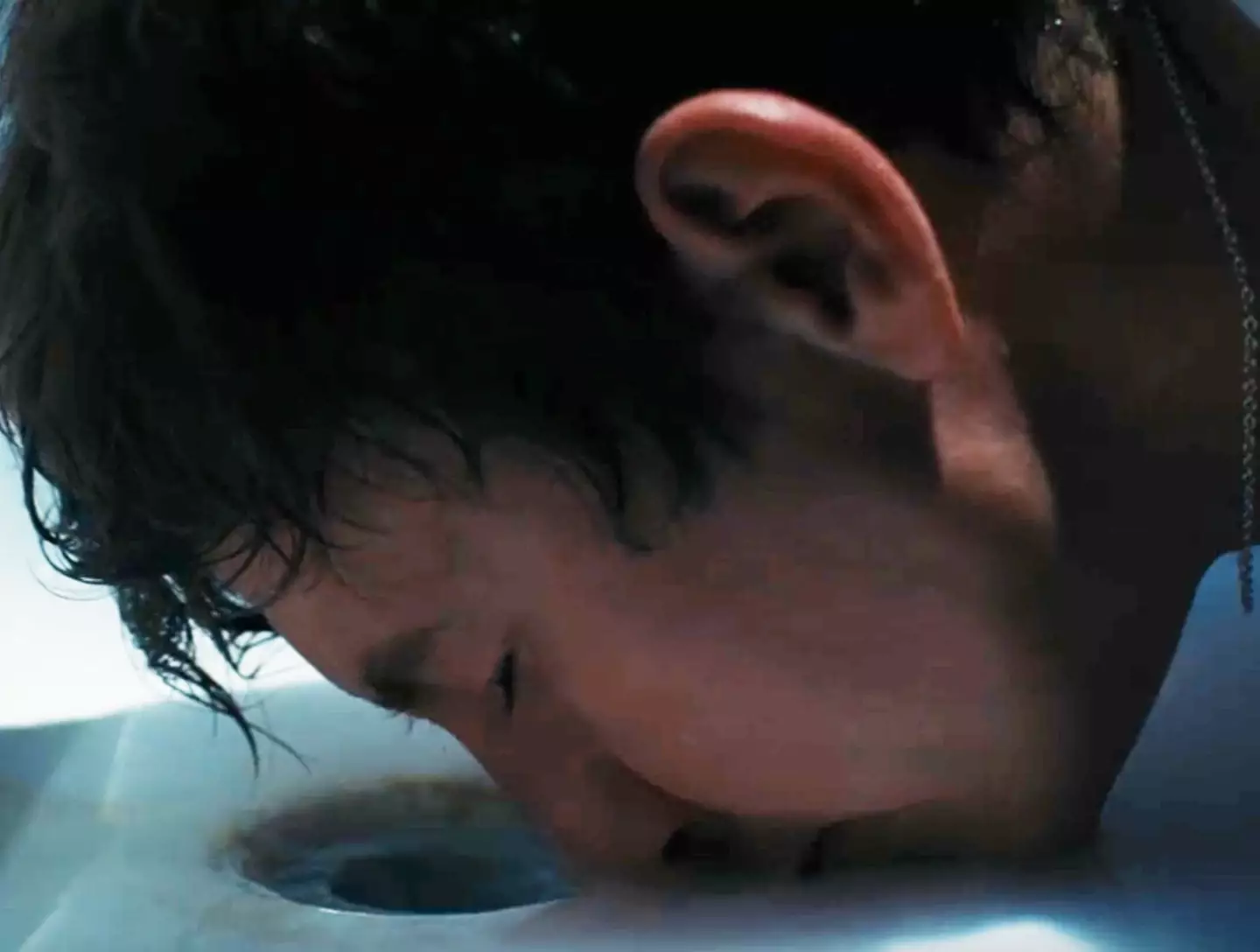 Barry Keoghan as Oliver drinking Felix's (Jacob Elordi) bath water in Saltburn.