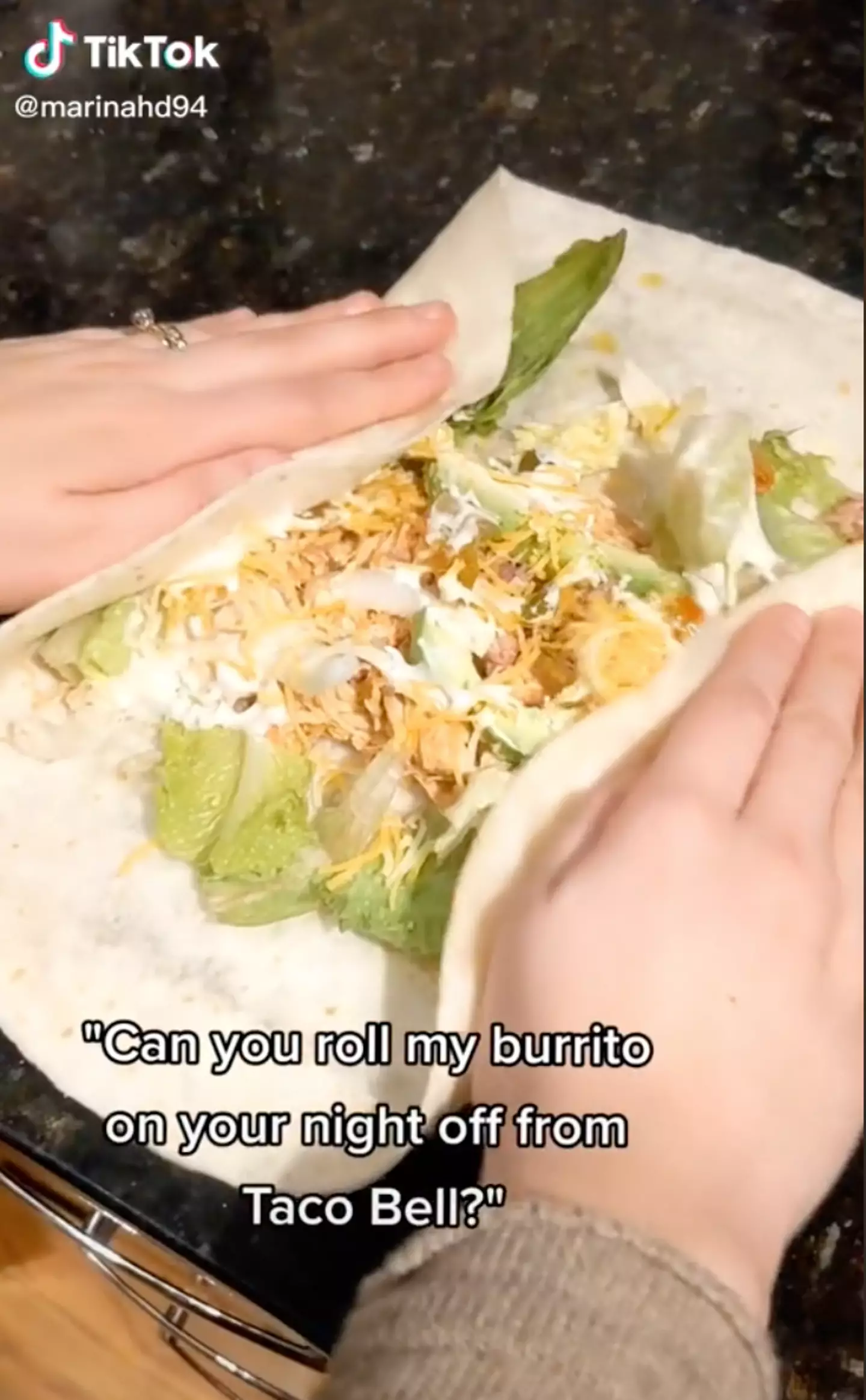Marina first folds the burrito (