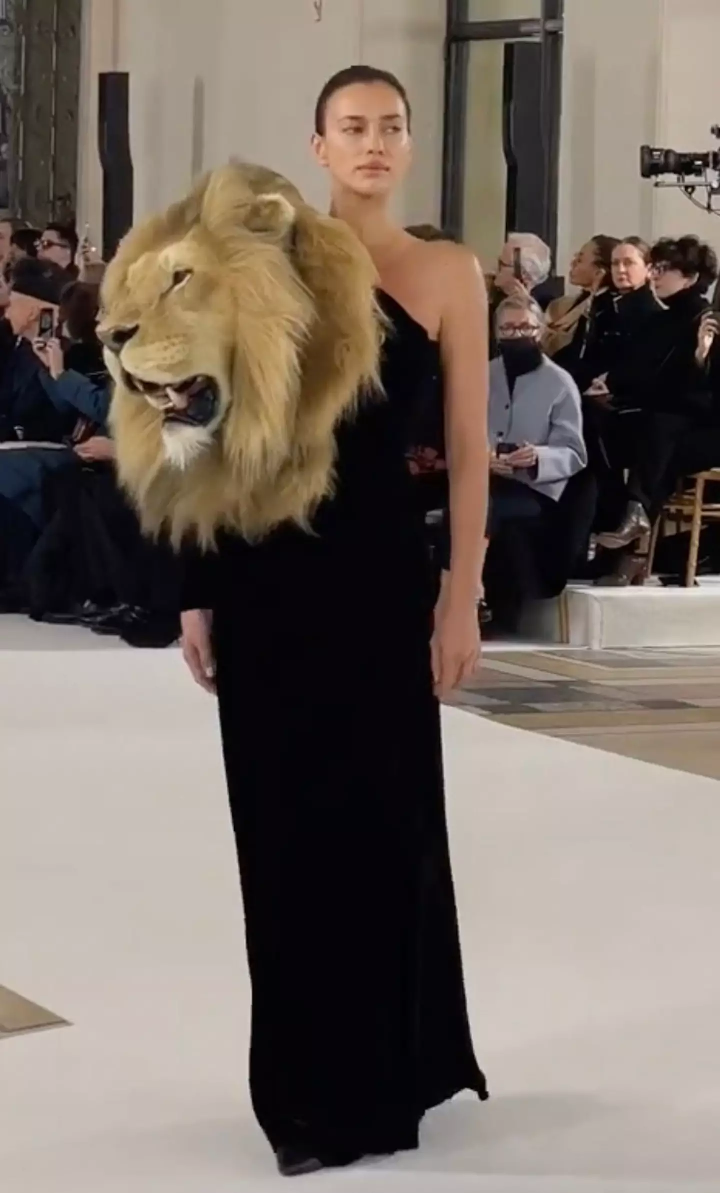 37-year-old Irina Shayk wearing a couture black gown fitted with an embroidered lion head for the Schiaparelli show.