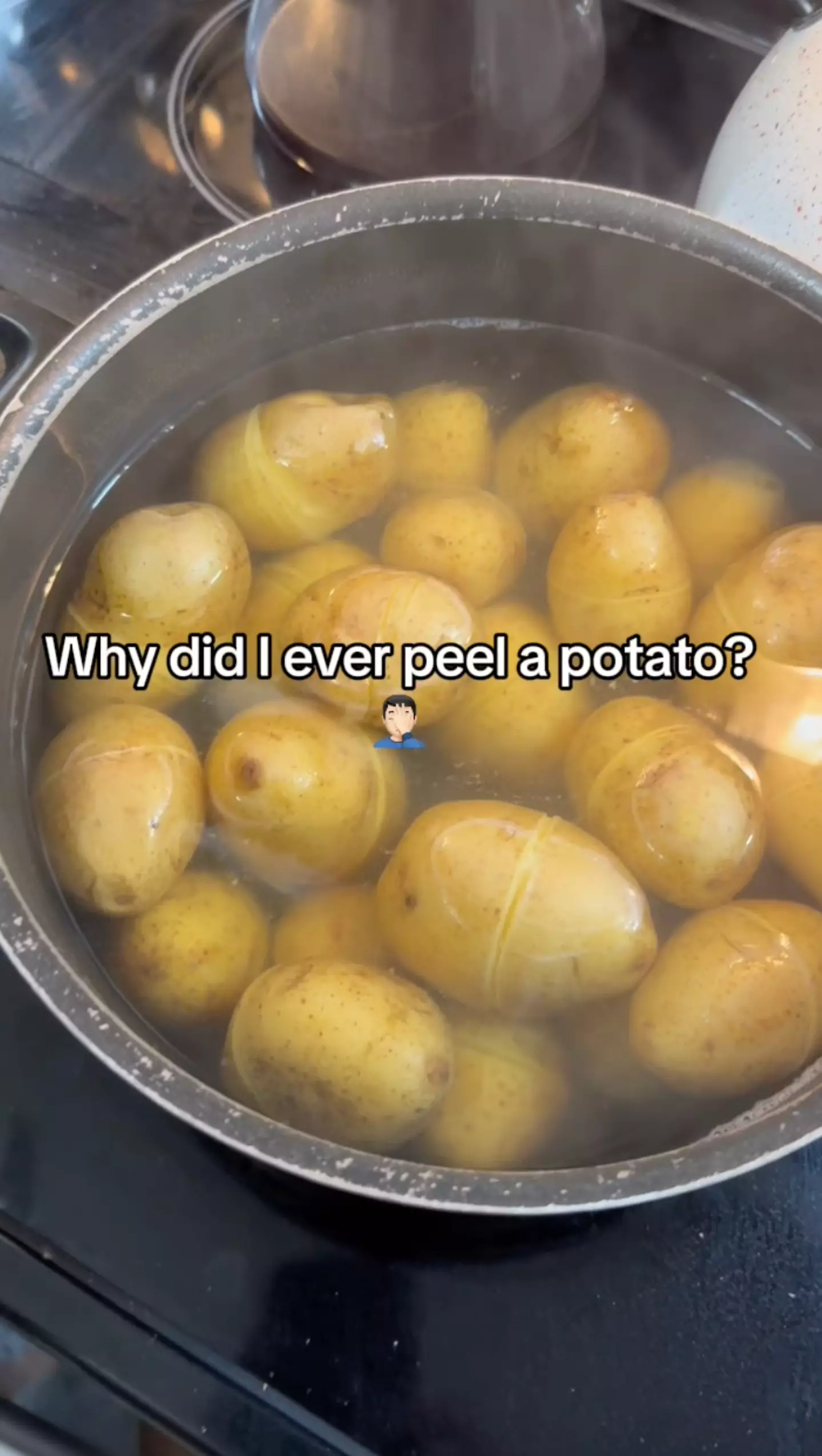 The woman scraped a line around the potatoes before boiling them.