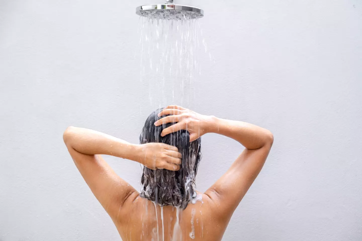 Experts have weighed in on how peeing in the shower can impact your health and wallet (Getty Stock Image)