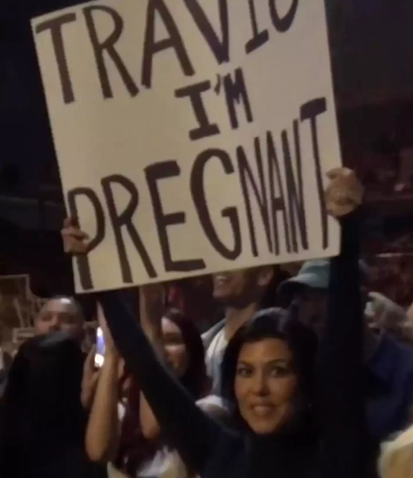 Kourtney held up a poster at the Blink 182 gig to announce her pregnancy.