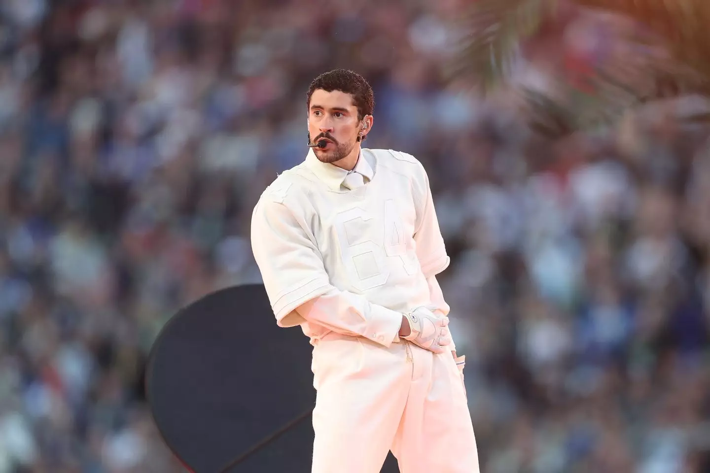 The rapper wore an all-white look from Zara, including a sports-style jersey with the number 64 (Chris Graythen/Getty Images)