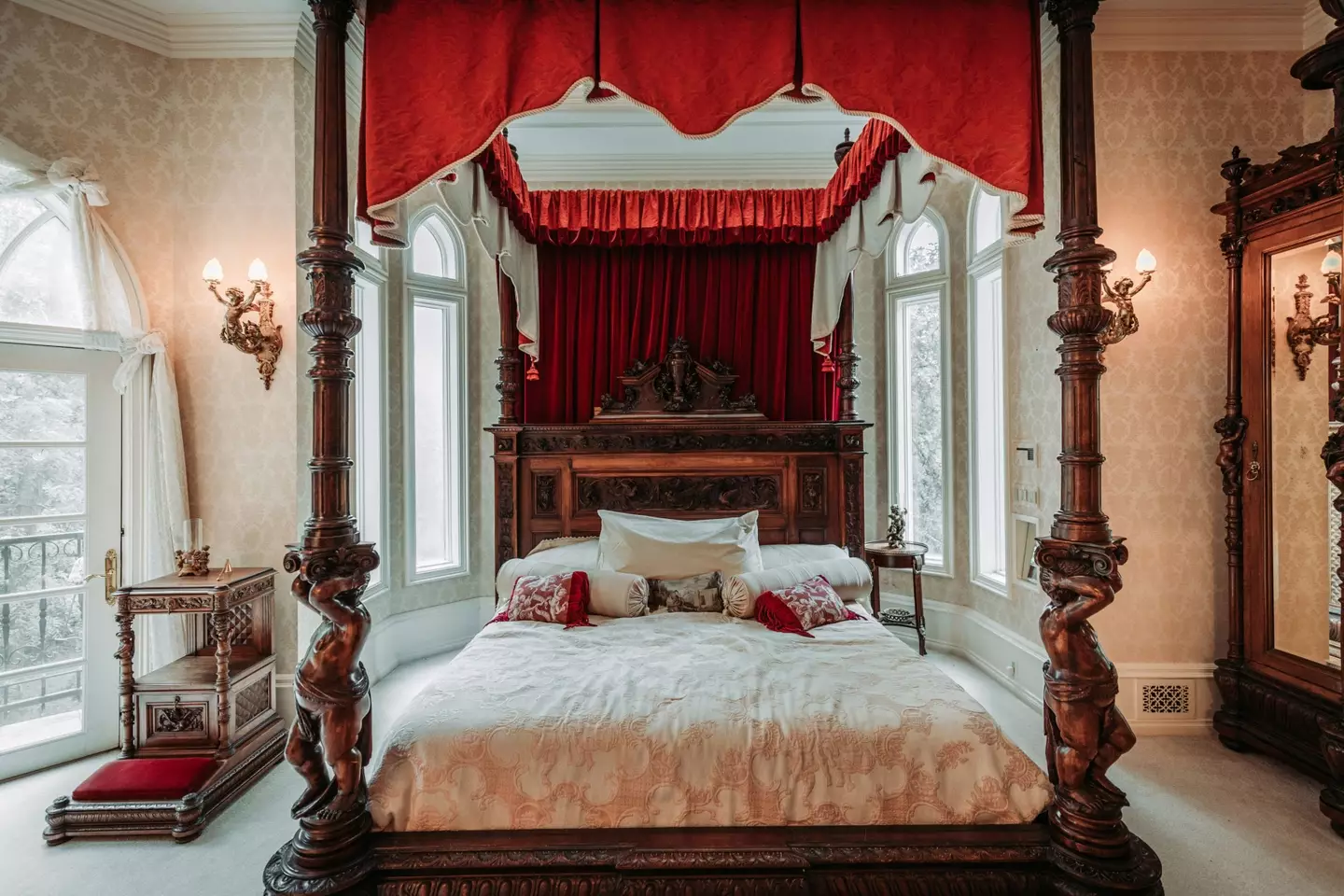 The master bedroom includes a four-poster bed and a balcony (